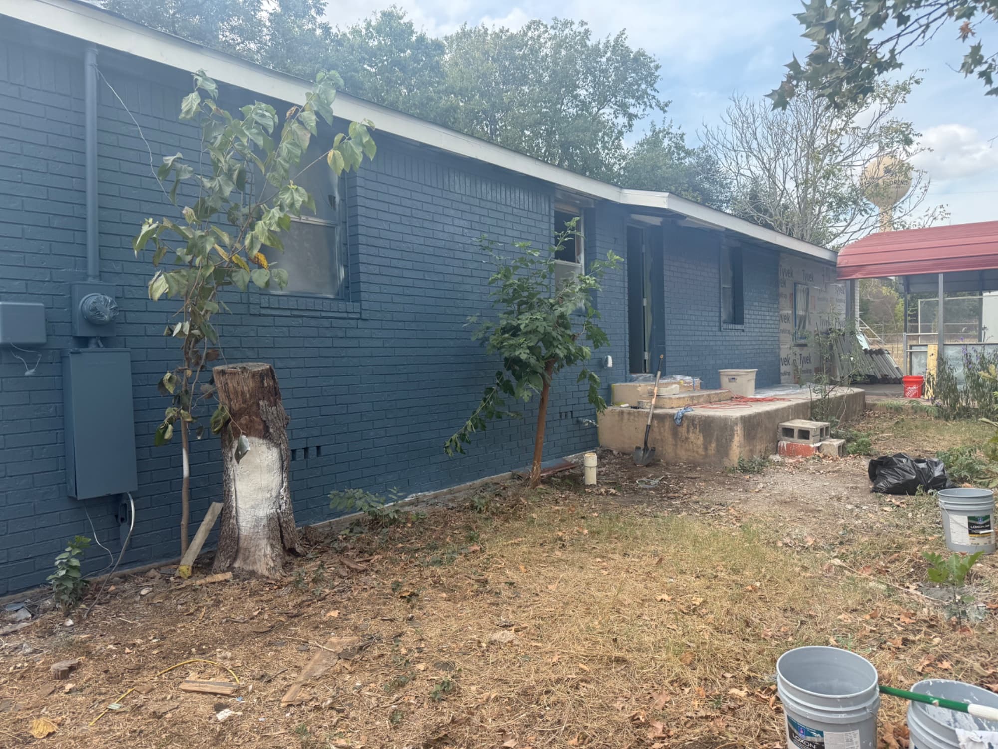 Before: Before and after full exterior brick painting – slate blue, Austin TX