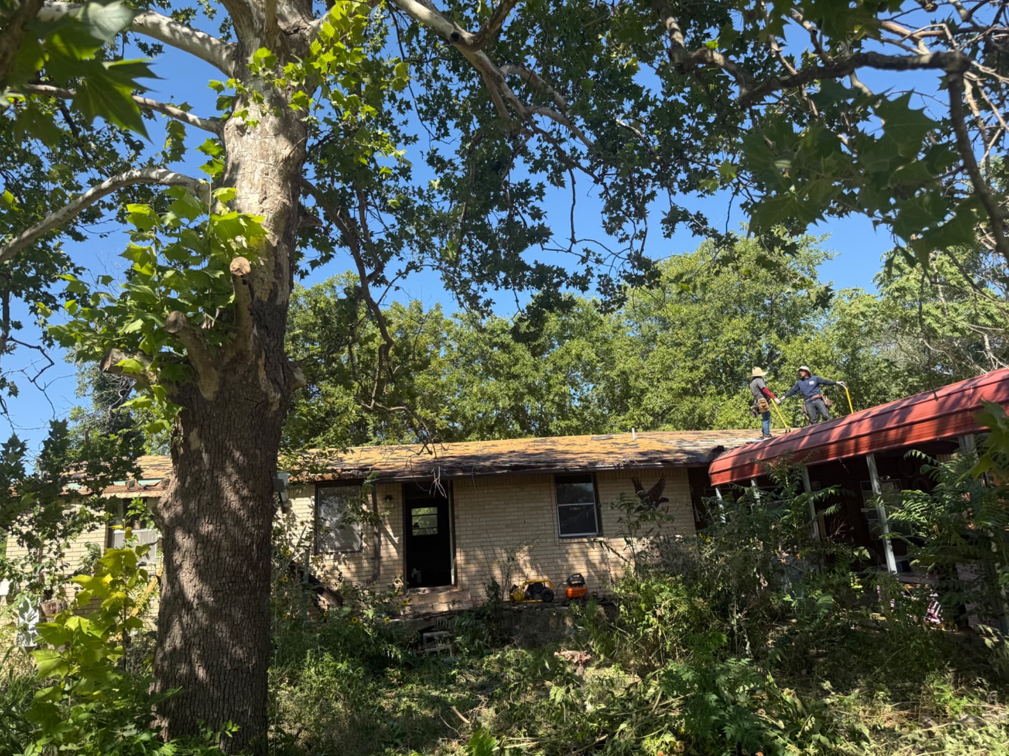 Before and after full exterior brick painting – slate blue, Austin TX