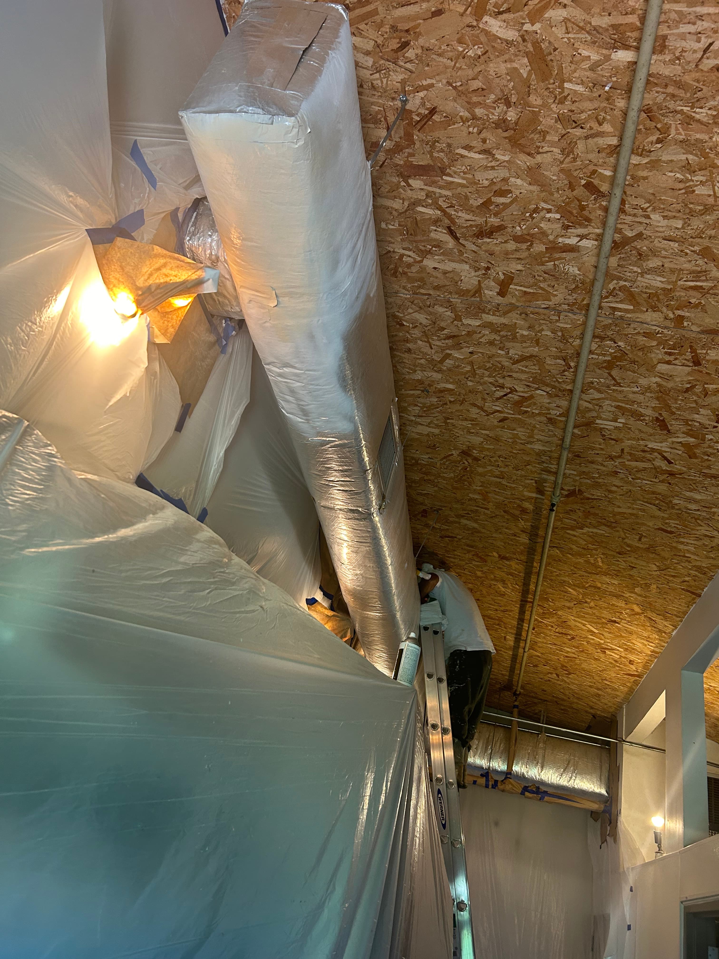Before and after commercial interior spray painting with HVAC vents masked for protection, Austin TX