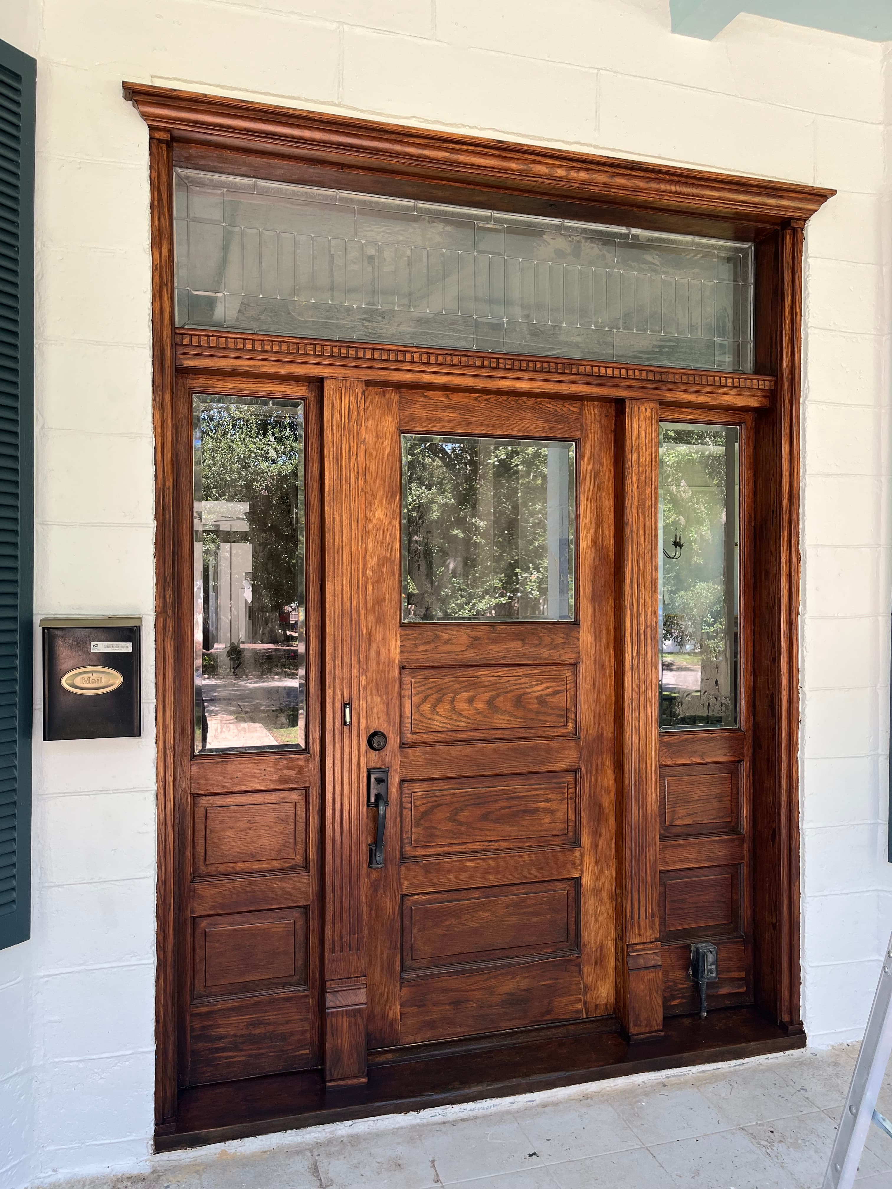 Before: Before and after wood stain refinish on grand entry door, Austin TX