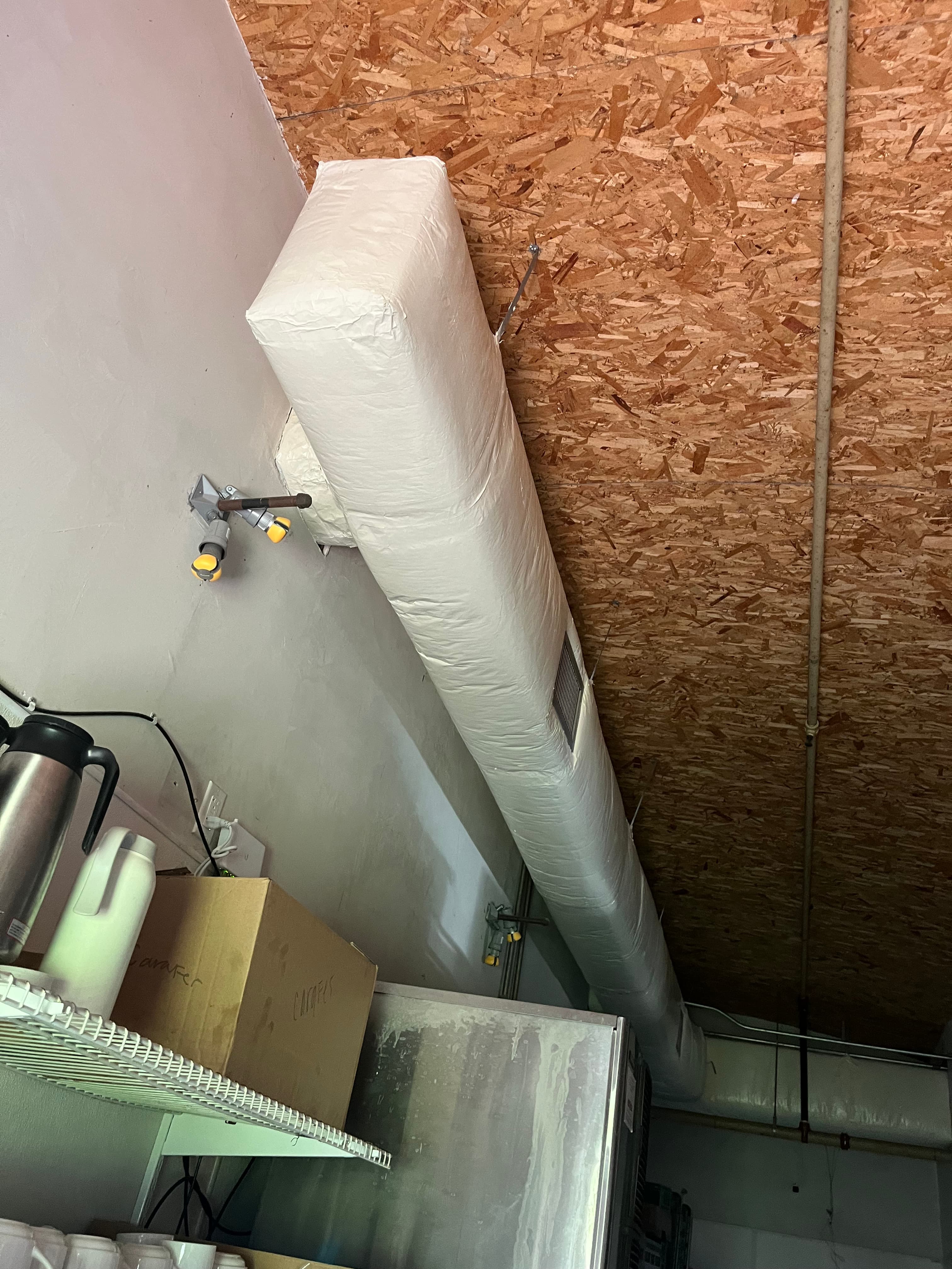 Before: Before and after commercial interior spray painting with HVAC vents masked for protection, Austin TX